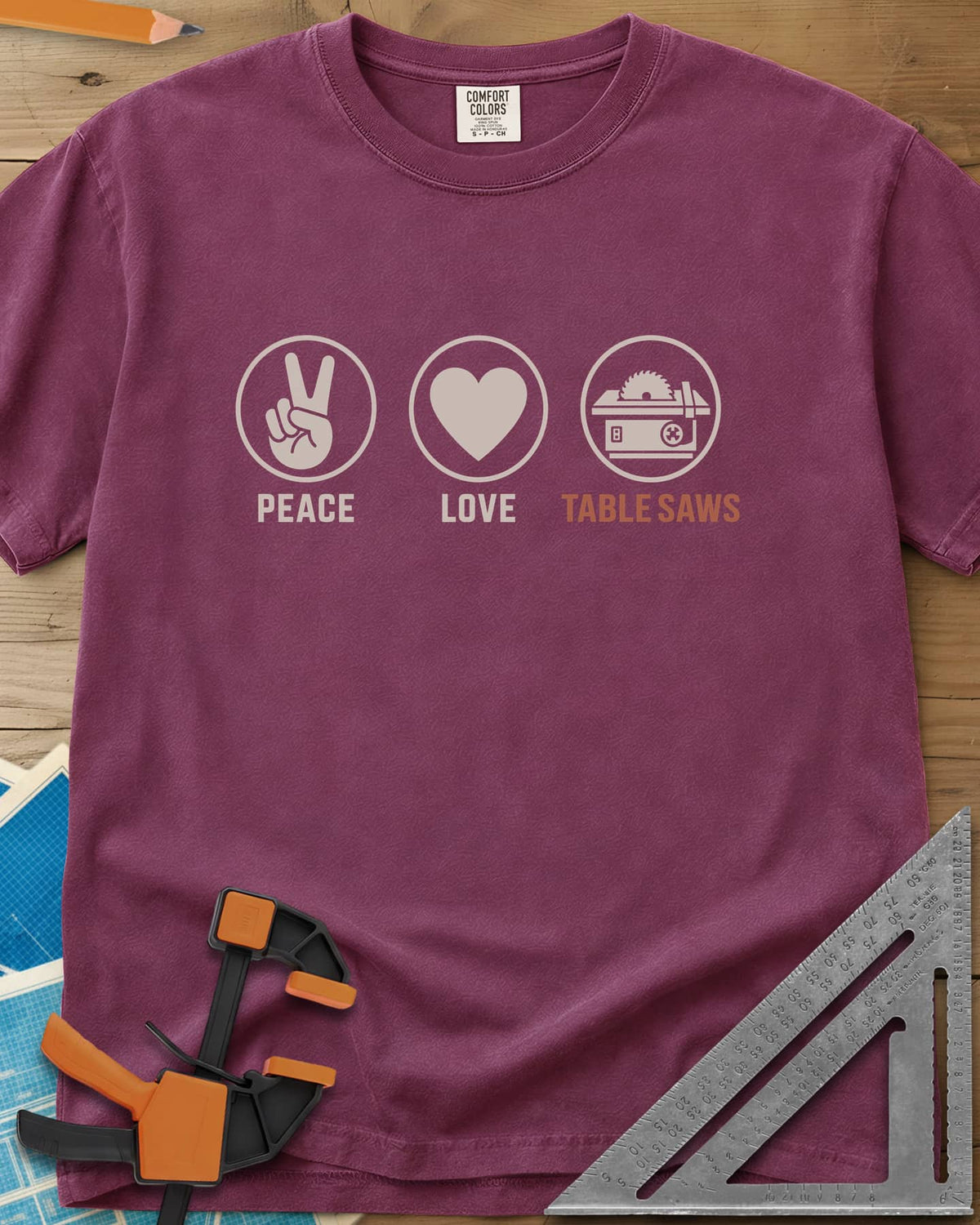 Peace Love Table Saws heavyweight tee in Berry, three circled icons: a peace sign, a heart and a table saw