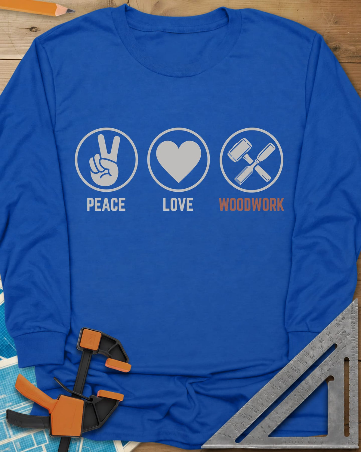 Peace Love Woodwork long sleeve shirt in Royal, three circled icons: a peace sign, a heart, a mallet and chisel