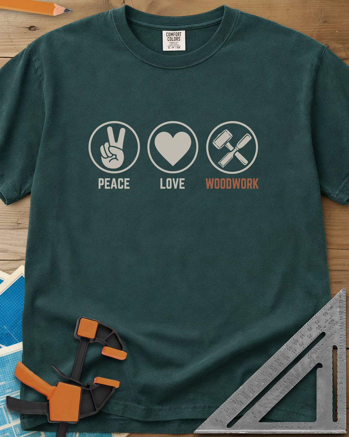 Peace Love Woodwork heavyweight tee in Blue Spruce, three circled icons: a peace sign, a heart, a mallet and chisel