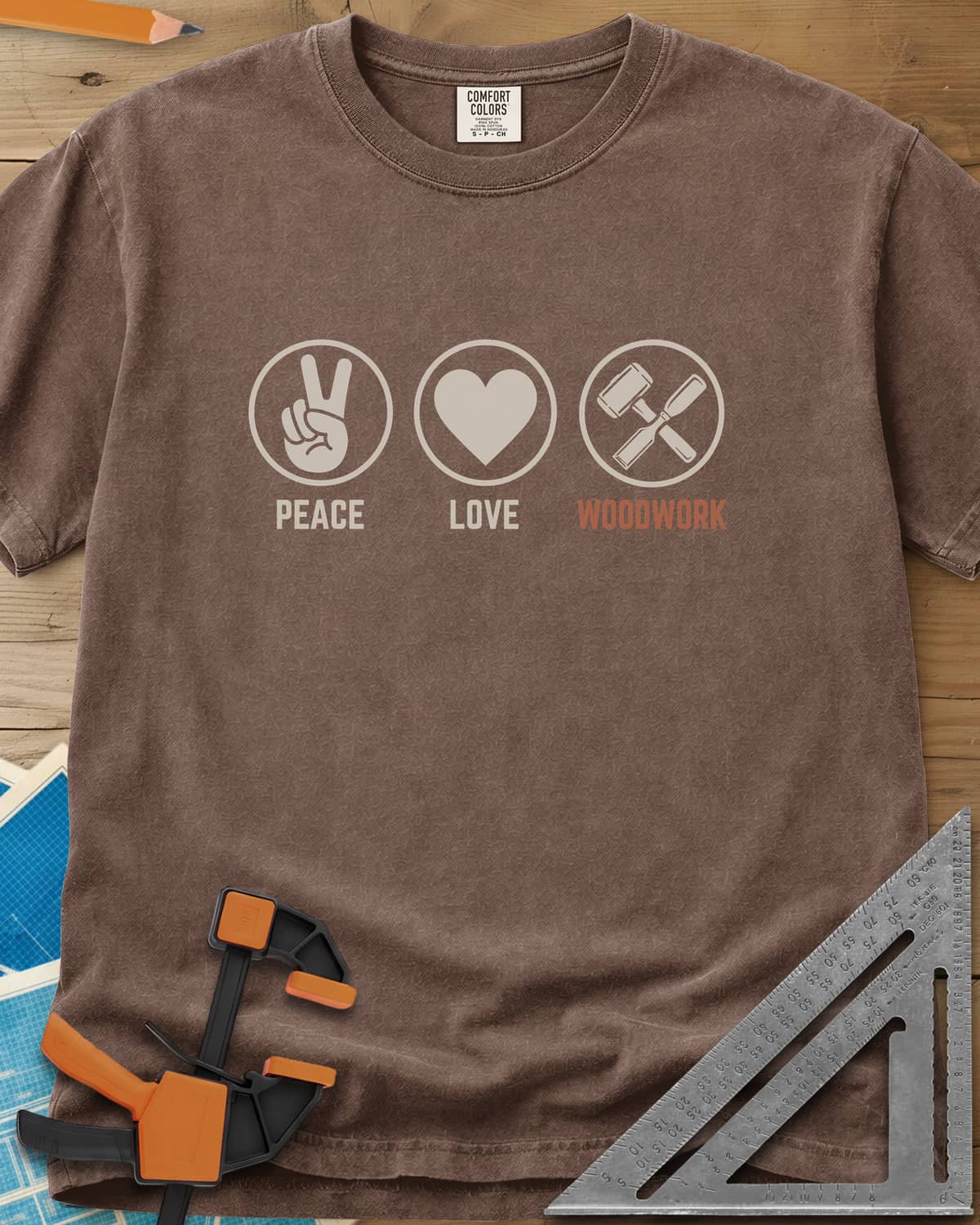Peace Love Woodwork heavyweight tee in Espresso, three circled icons: a peace sign, a heart, a mallet and chisel