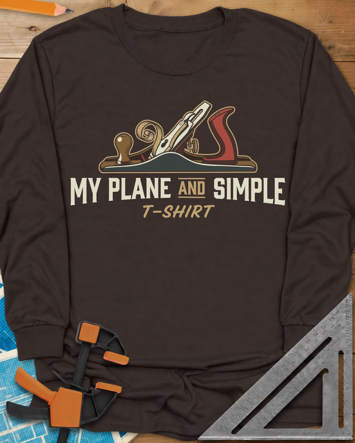 Plane and Simple long sleeve shirt in Dark Chocolate, a hand plane with a wood curl above a pun caption