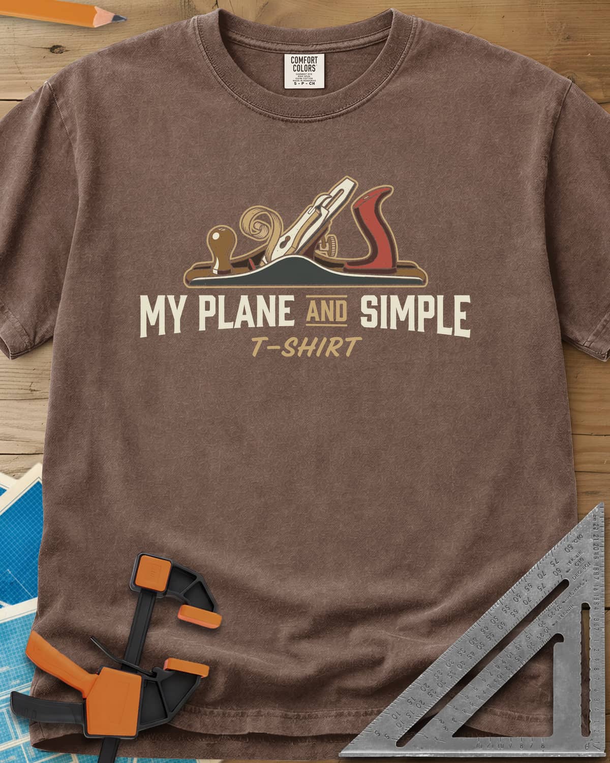 Plane and Simple heavyweight tee in Espresso, a hand plane with a wood curl above a pun caption