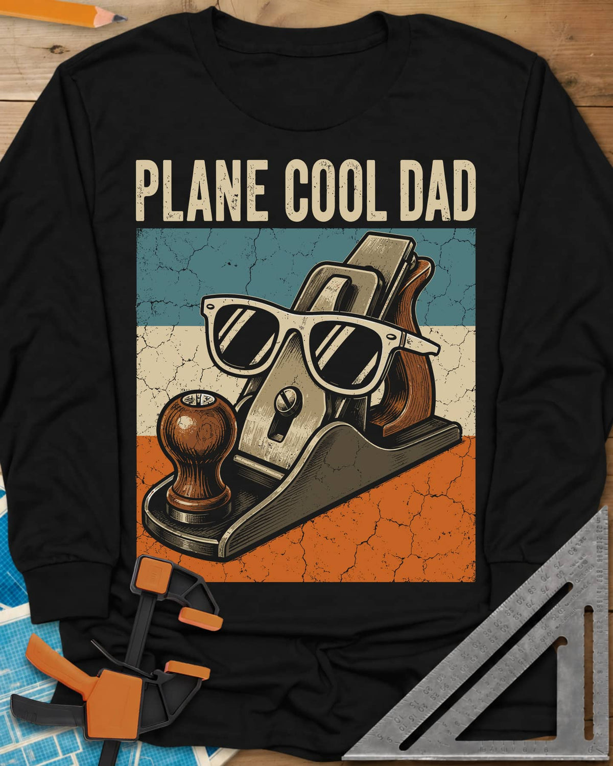 Plane Cool Dad long sleeve shirt in Black, a hand plane in white sunglasses on a retro striped panel