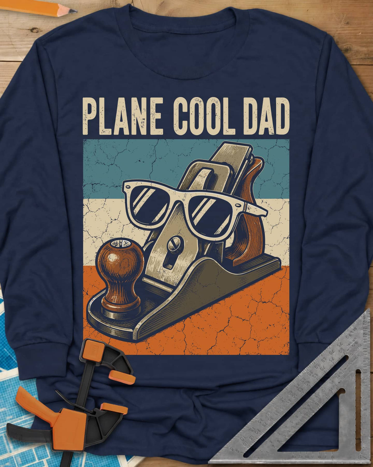 Plane Cool Dad long sleeve shirt in Navy, a hand plane in white sunglasses on a retro striped panel