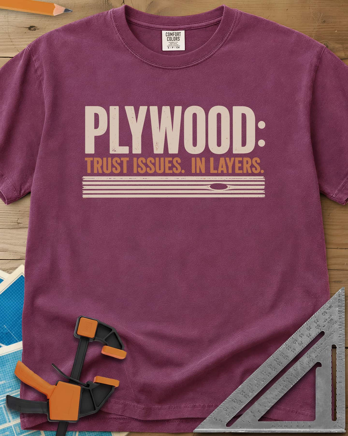 Plywood Trust heavyweight tee in Berry, striped plywood layers with an oval knot patch
