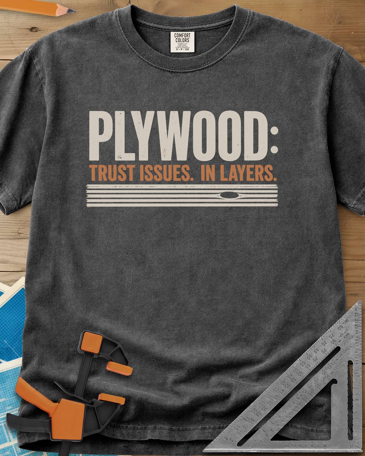 Plywood Trust heavyweight tee in Pepper, striped plywood layers with an oval knot patch