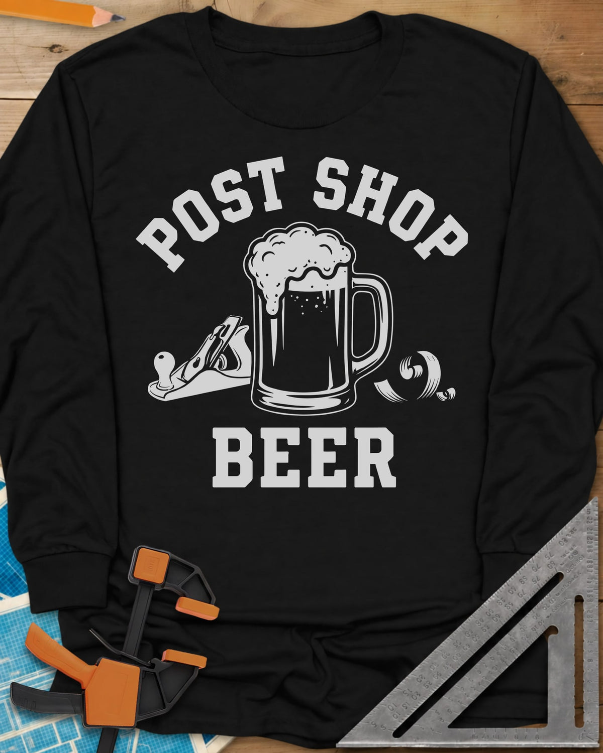 Post Shop Beer Woodworking long sleeve shirt in Black, a frothy beer mug flanked by a hand plane and a wood shaving