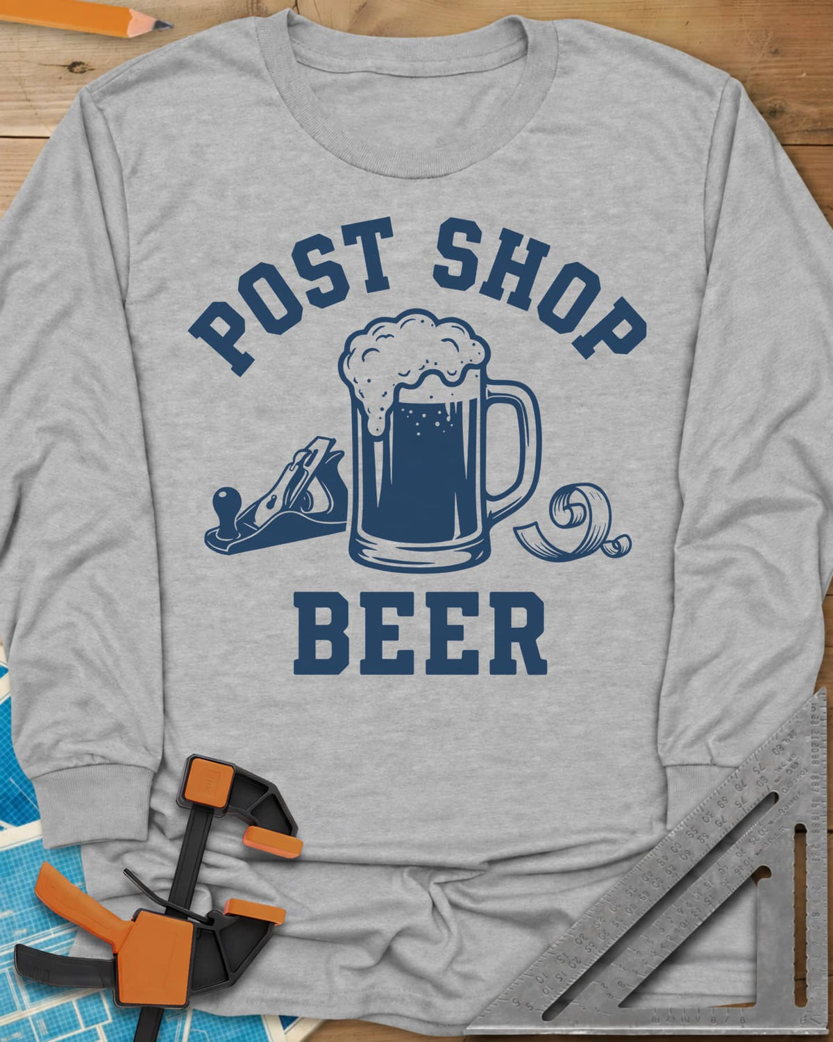 Post Shop Beer Woodworking long sleeve shirt in Sport Grey, a frothy beer mug flanked by a hand plane and a wood shaving