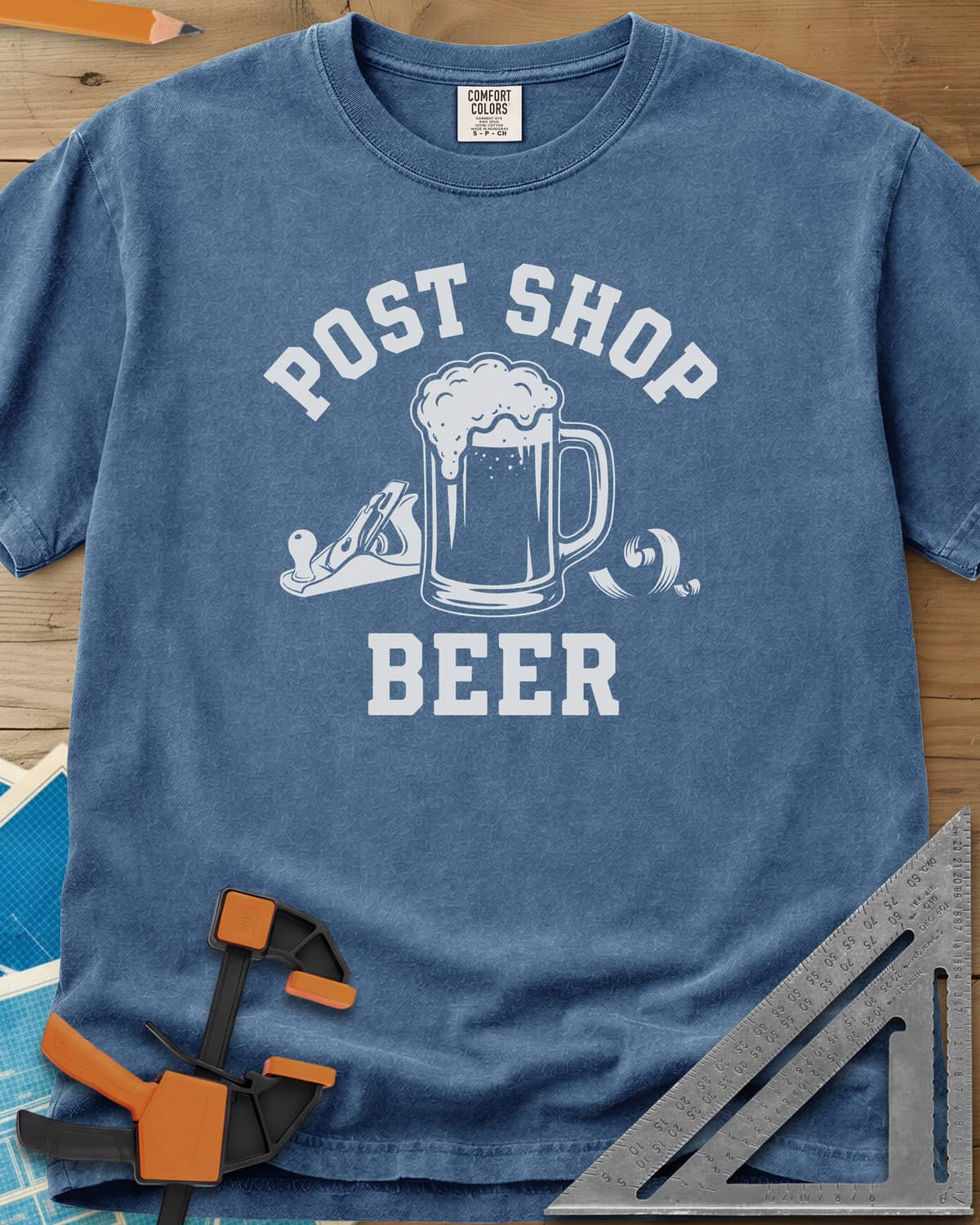 Post Shop Beer Woodworking heavyweight tee in Blue Jean, a frothy beer mug flanked by a hand plane and a wood shaving