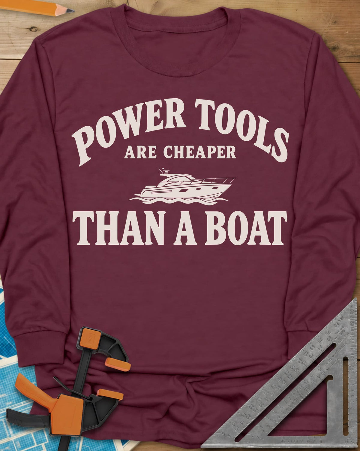 Power Tools Are Cheaper Than A Boat long sleeve shirt in Maroon, a line-drawn motor yacht on waves between the words