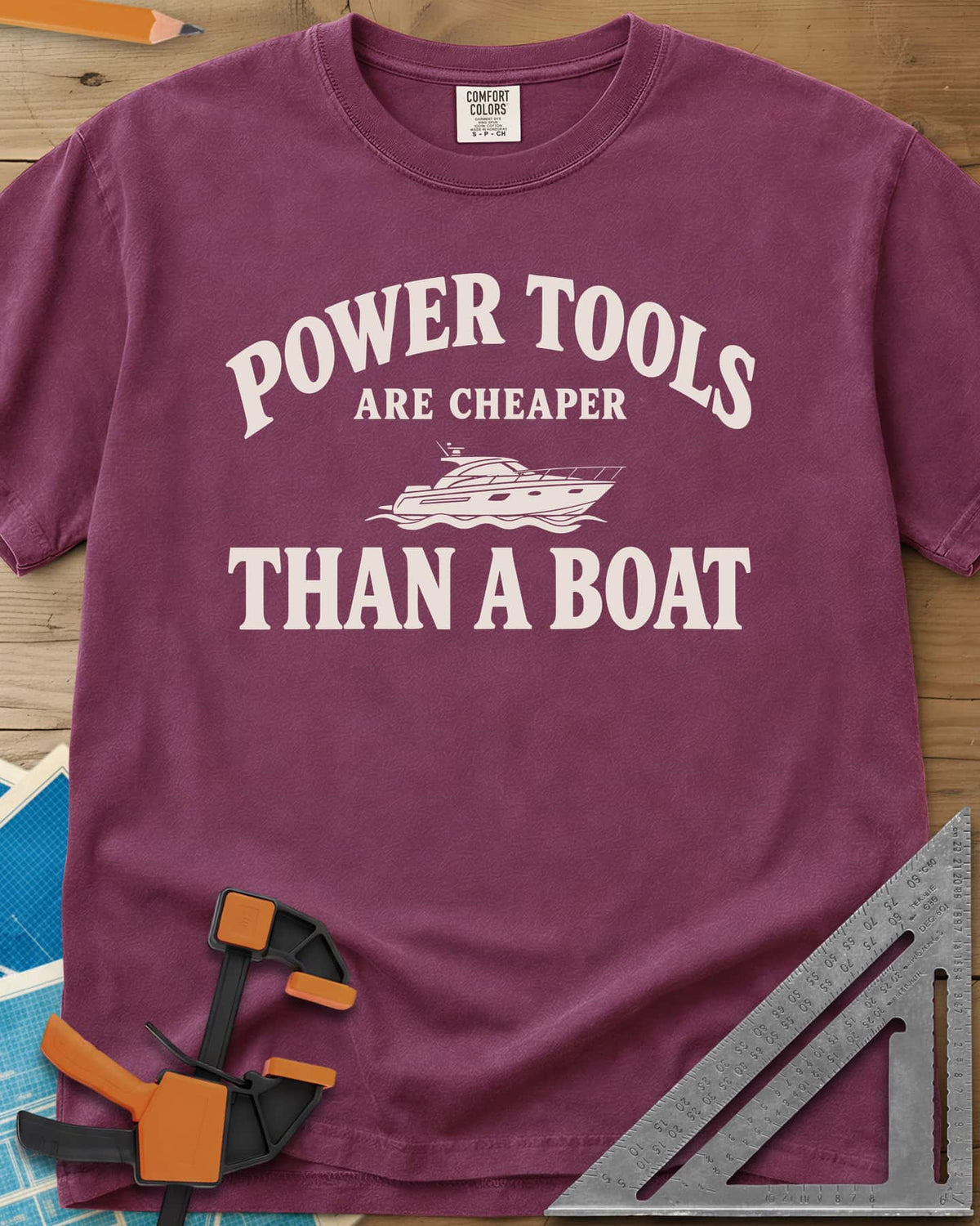 Power Tools Are Cheaper Than A Boat heavyweight tee in Berry, a line-drawn motor yacht on waves between the words