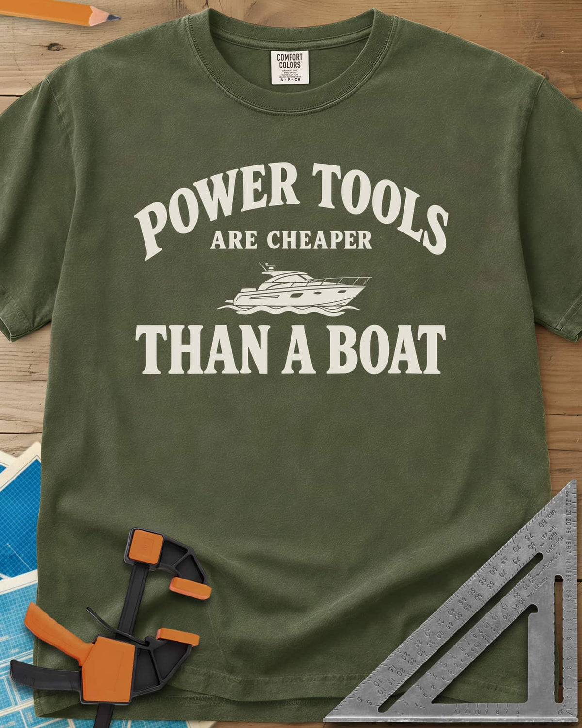 Power Tools Are Cheaper Than A Boat heavyweight tee in Hemp, a line-drawn motor yacht on waves between the words