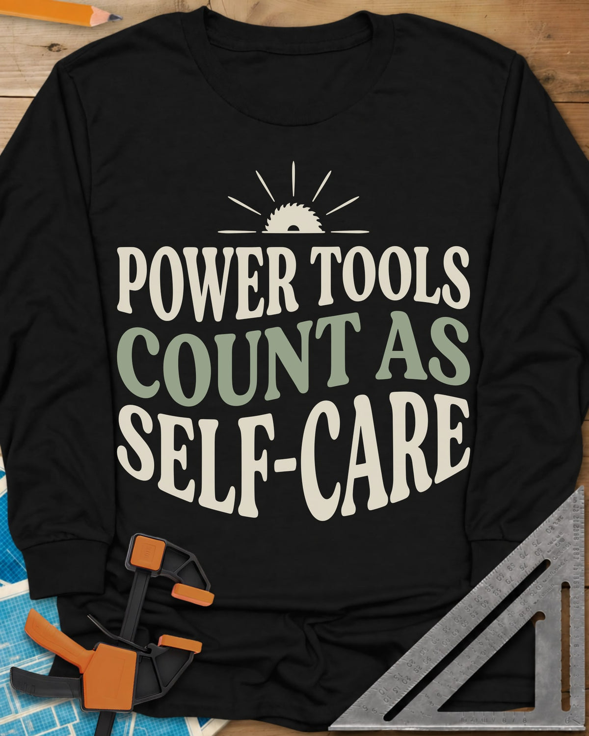 Power Tools Count As Self-Care long sleeve shirt in Black, wavy stacked lettering under a half saw blade rising like a sun