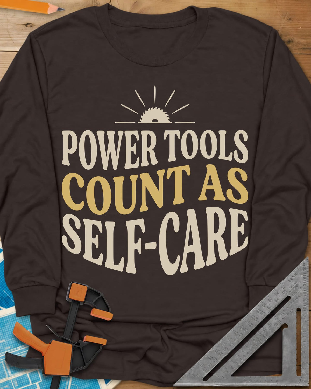 Power Tools Count As Self-Care long sleeve shirt in Dark Chocolate, wavy stacked lettering under a half saw blade rising