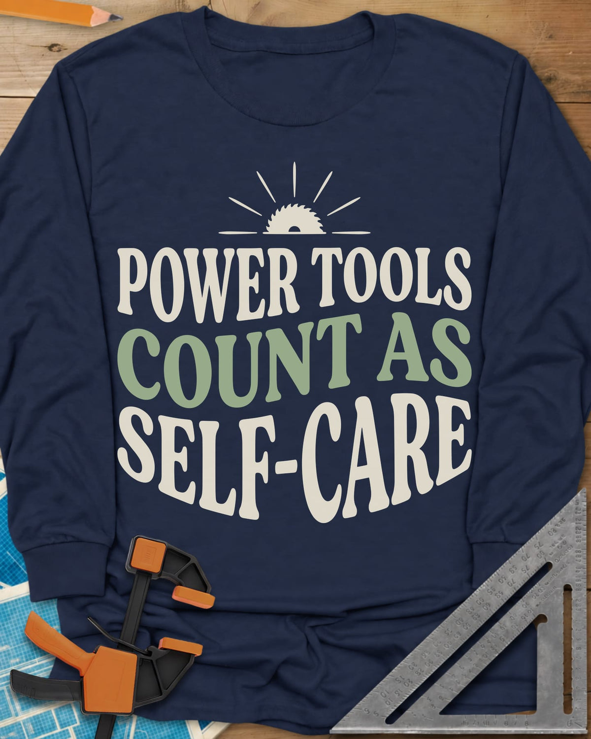 Power Tools Count As Self-Care long sleeve shirt in Navy, wavy stacked lettering under a half saw blade rising like a sun