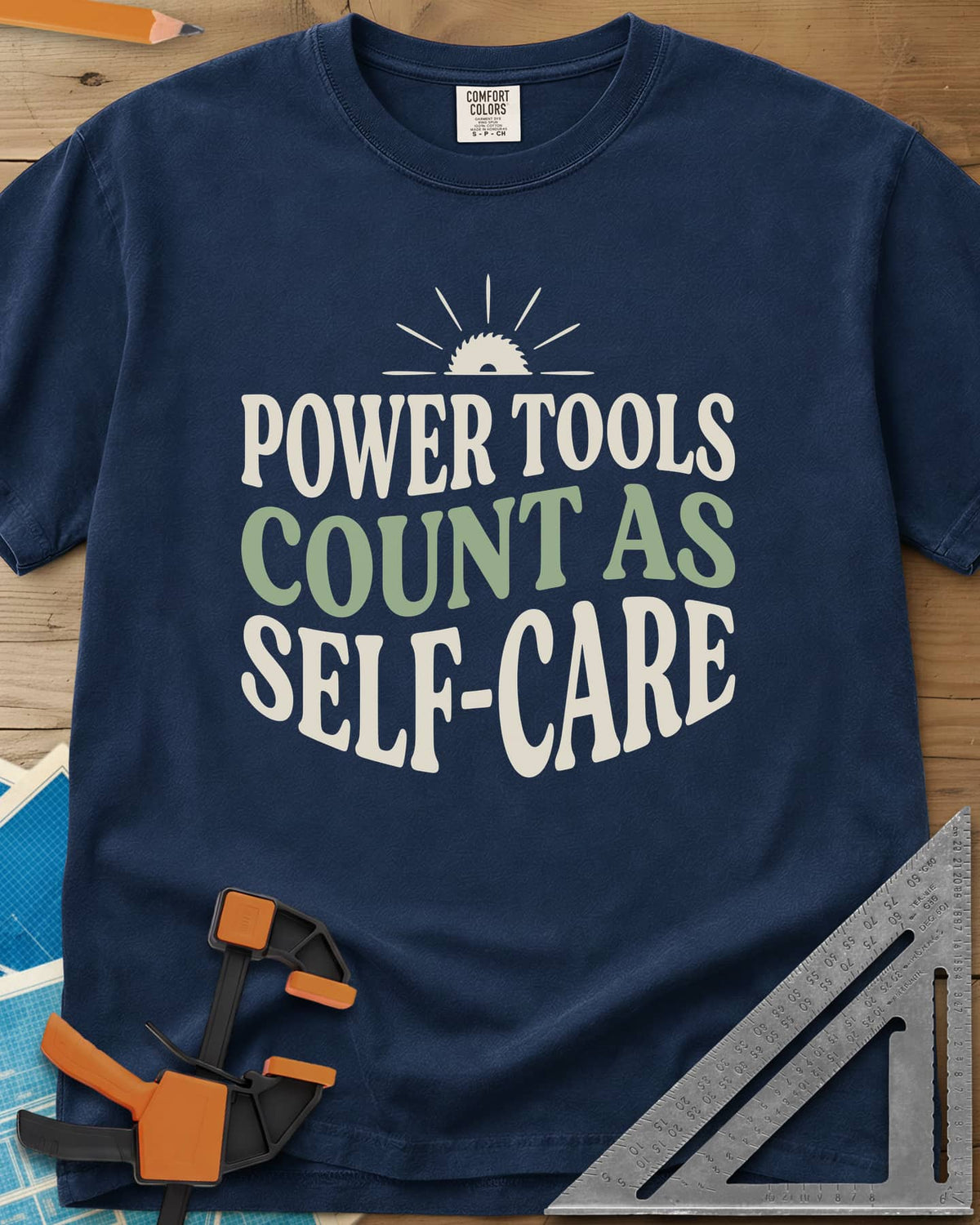 Power Tools Count As Self-Care heavyweight tee in Navy, wavy stacked lettering under a half saw blade rising like a sun