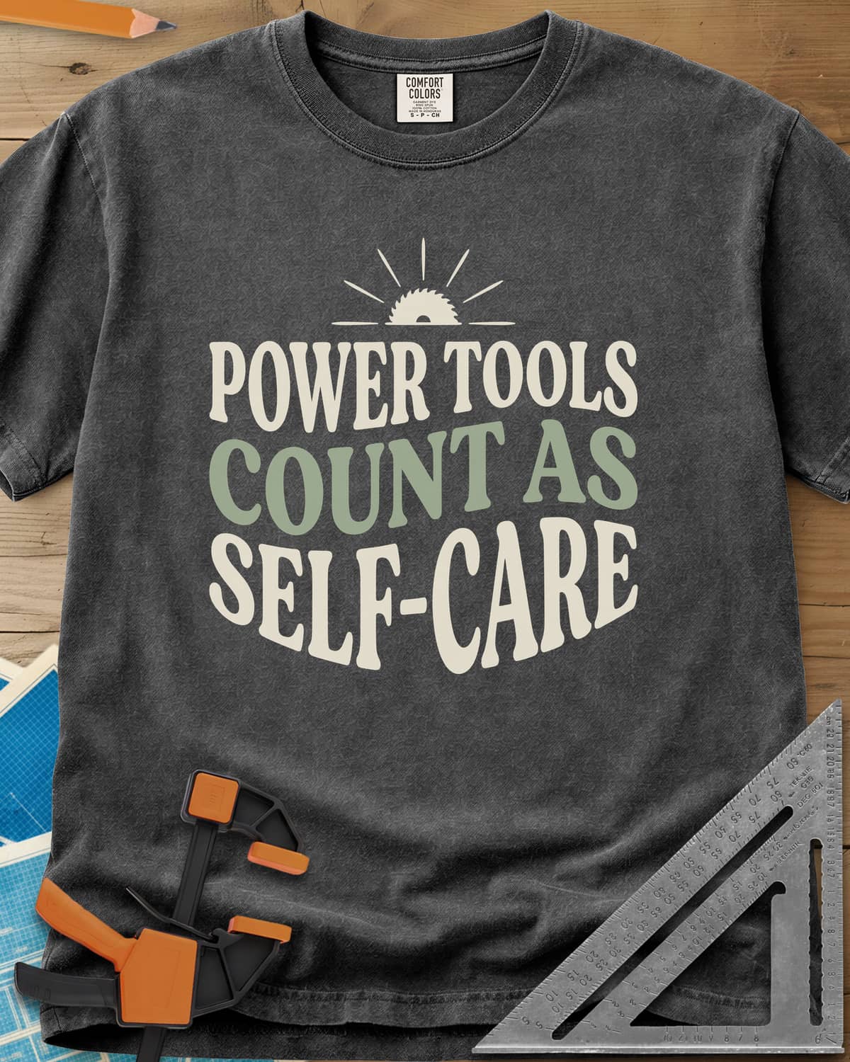 Power Tools Count As Self-Care heavyweight tee in Pepper, wavy stacked lettering under a half saw blade rising like a sun