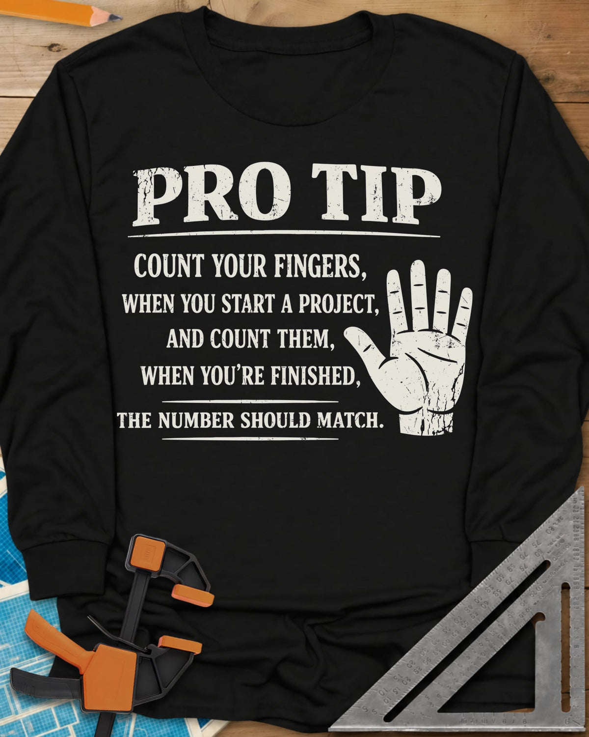 Pro Tip long sleeve shirt in Black, a raised open hand beside a shop-safety tip about counting fingers