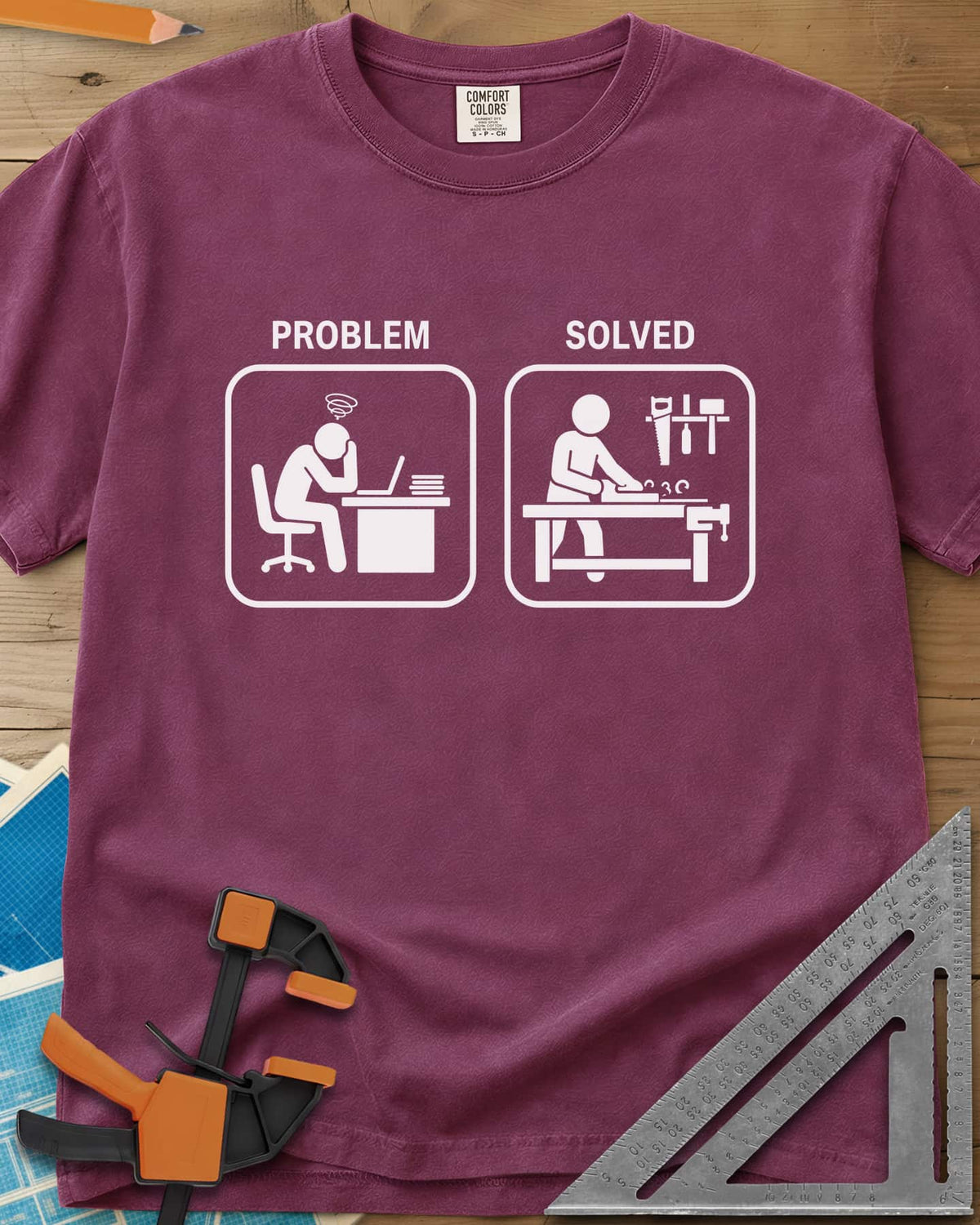 Problem Solved heavyweight tee in Berry, two pictogram panels, a stressed desk worker and a woodworker planing