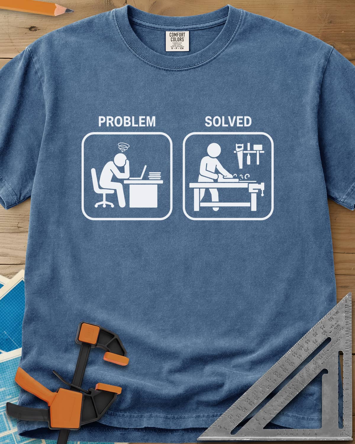 Problem Solved heavyweight tee in Blue Jean, two pictogram panels, a stressed desk worker and a woodworker planing