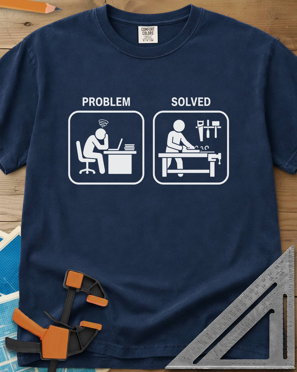Problem Solved heavyweight tee in Navy, two pictogram panels, a stressed desk worker and a woodworker planing