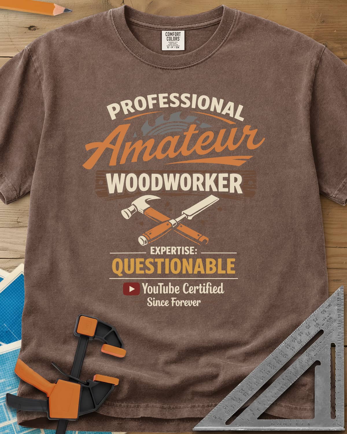 Professional Amateur heavyweight tee in Espresso, a saw blade, crossed hammer and chisel, and a YouTube play button
