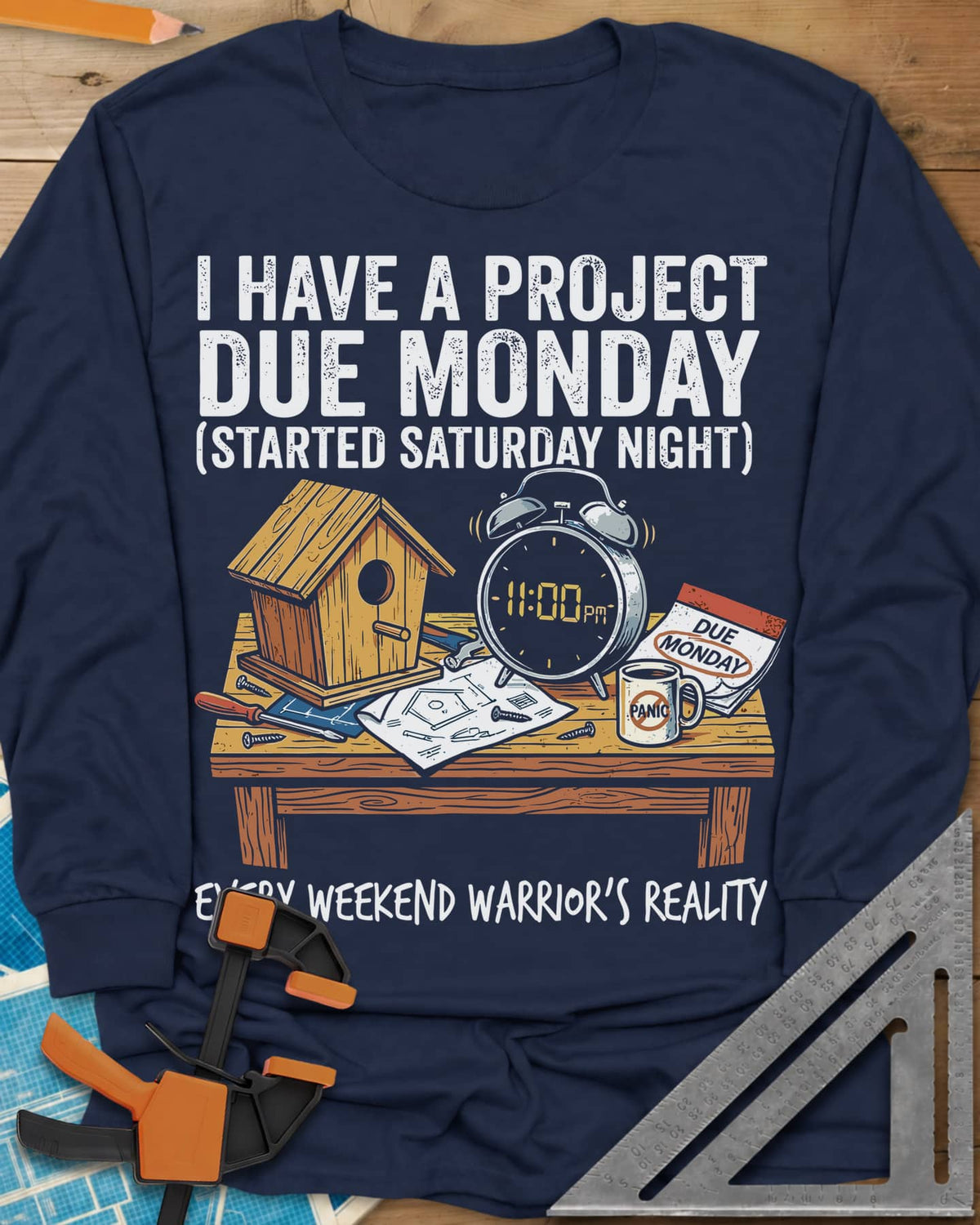 Project Due Monday long sleeve shirt in Navy, unfinished birdhouse on a bench with an 11 PM alarm clock and plans