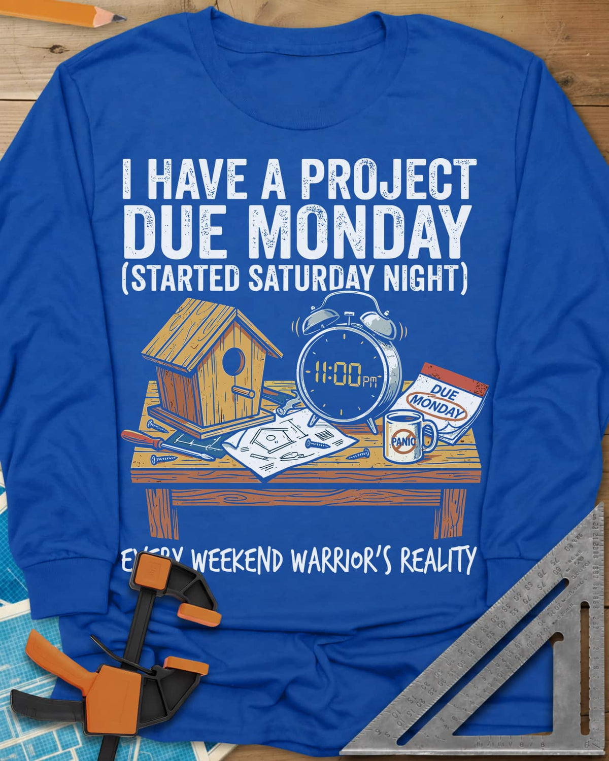 Project Due Monday long sleeve shirt in Royal, unfinished birdhouse on a bench with an 11 PM alarm clock and plans