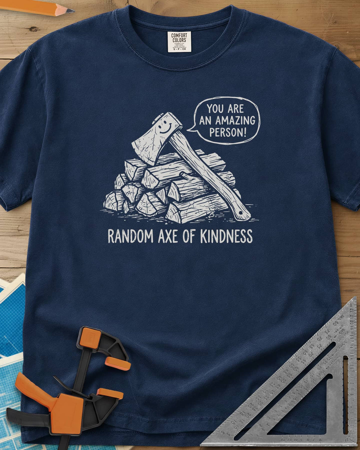 Random Axe of Kindness heavyweight tee in Navy, a smiling axe on a woodpile with an encouraging speech bubble