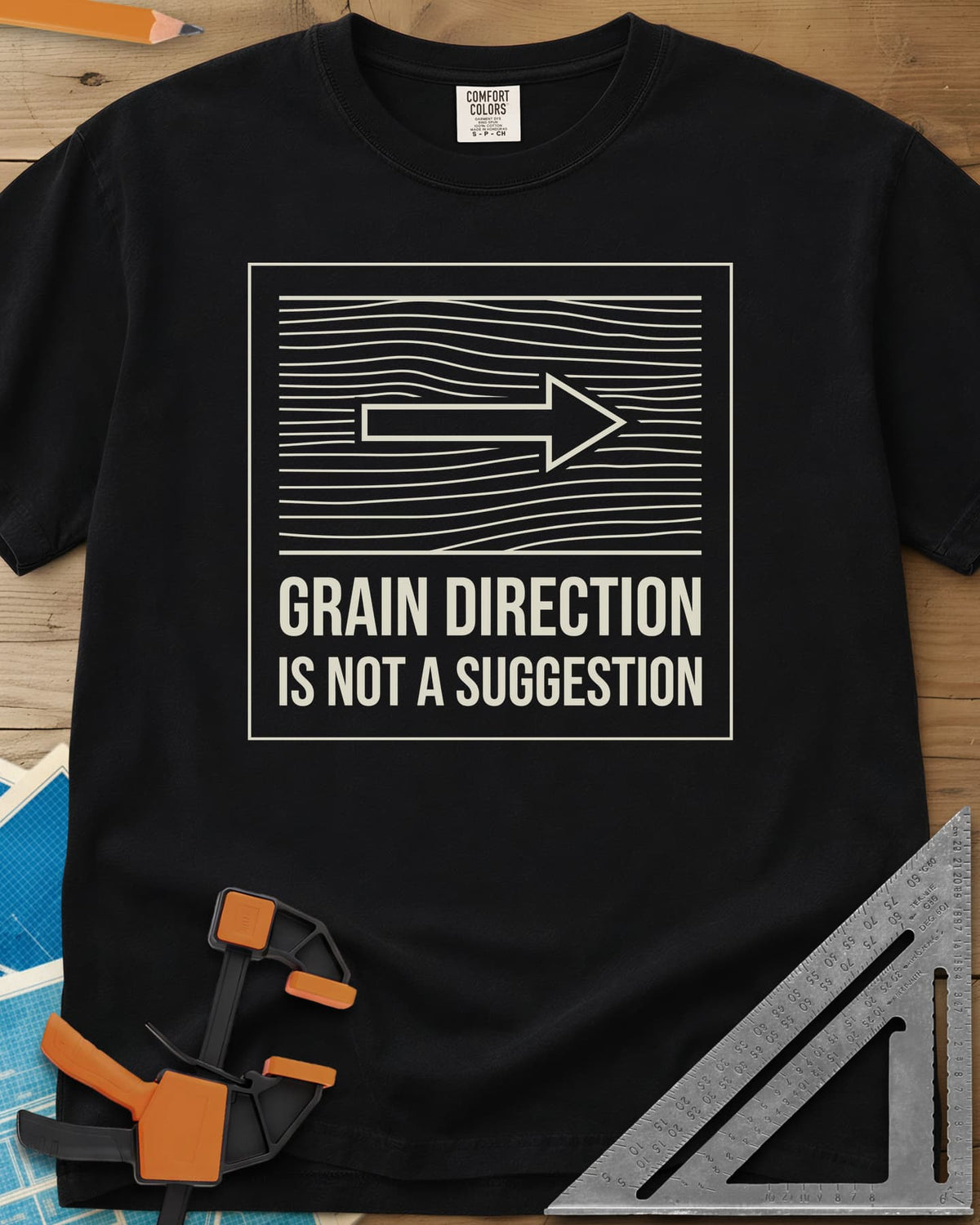 Respect The Grain heavyweight tee in Black, boxed wood grain lines with an arrow showing grain direction