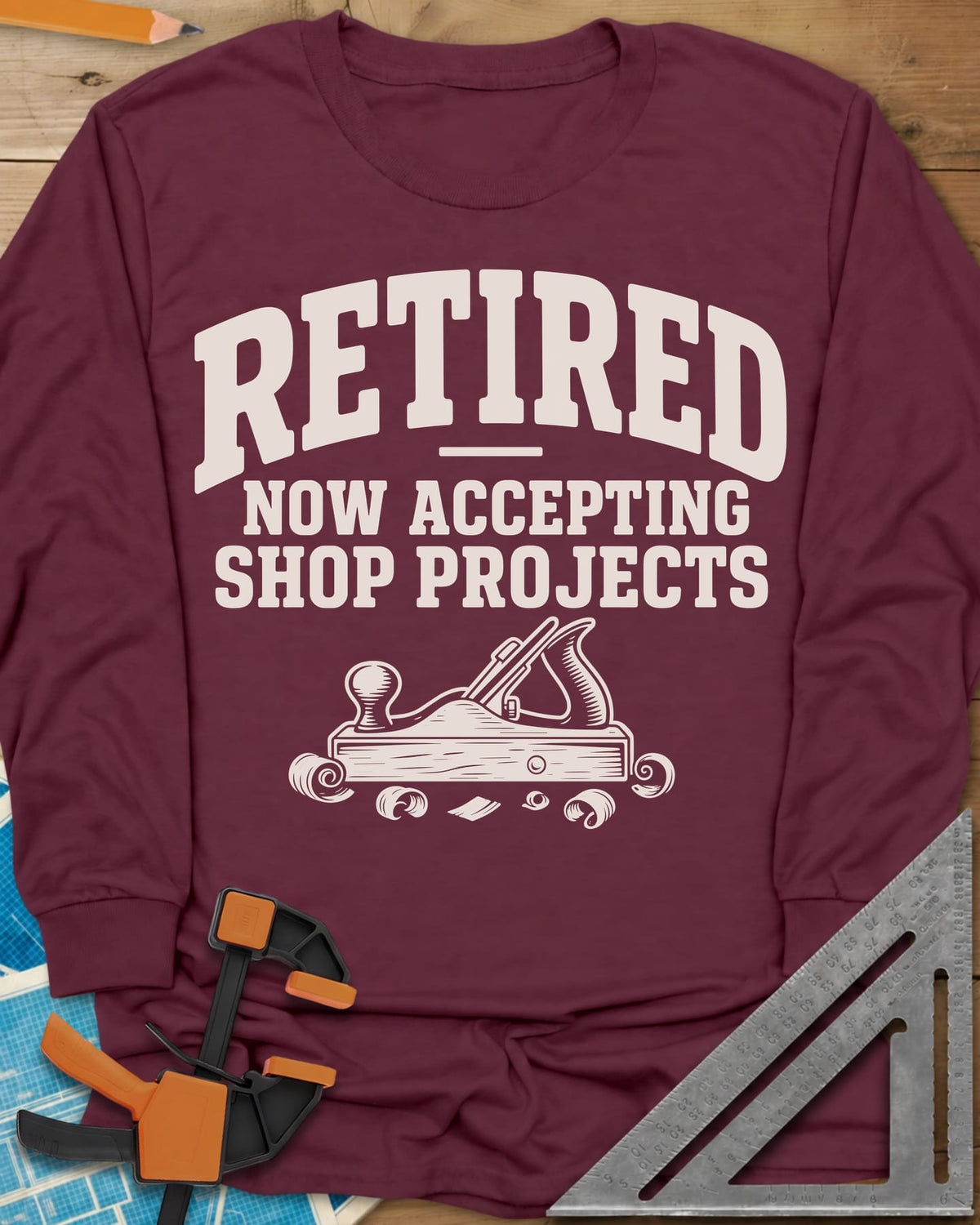 Retired Projects long sleeve shirt in Maroon, a hand plane with curled shavings under varsity RETIRED lettering