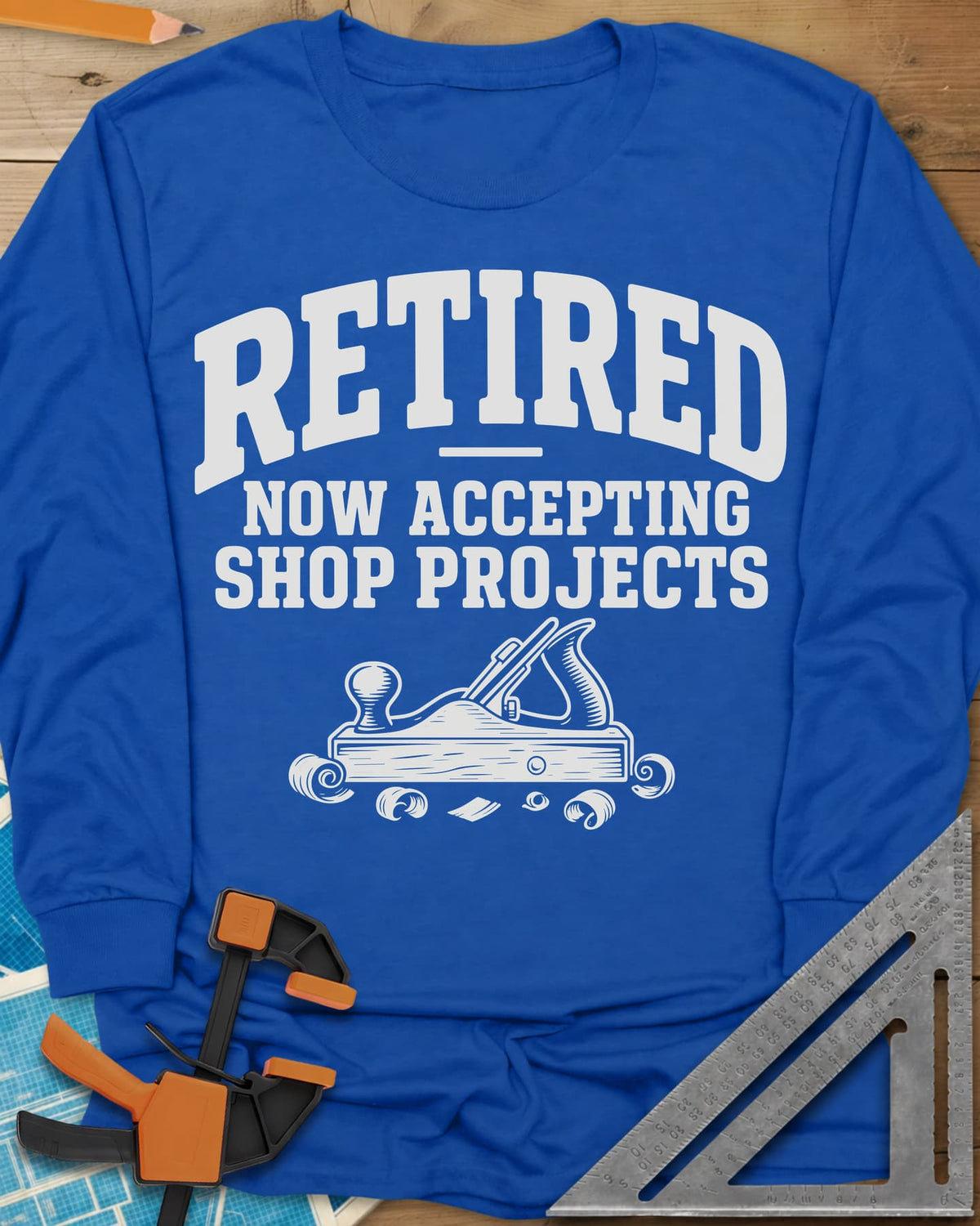 Retired Projects long sleeve shirt in Royal, a hand plane with curled shavings under varsity RETIRED lettering