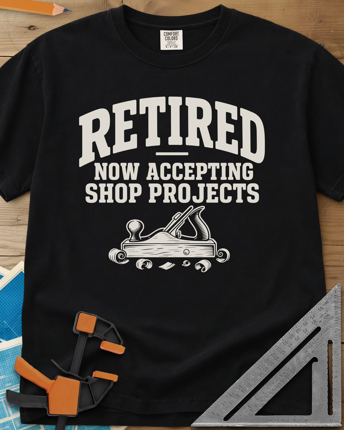 Retired Projects heavyweight tee in Black, a hand plane with curled shavings under varsity RETIRED lettering