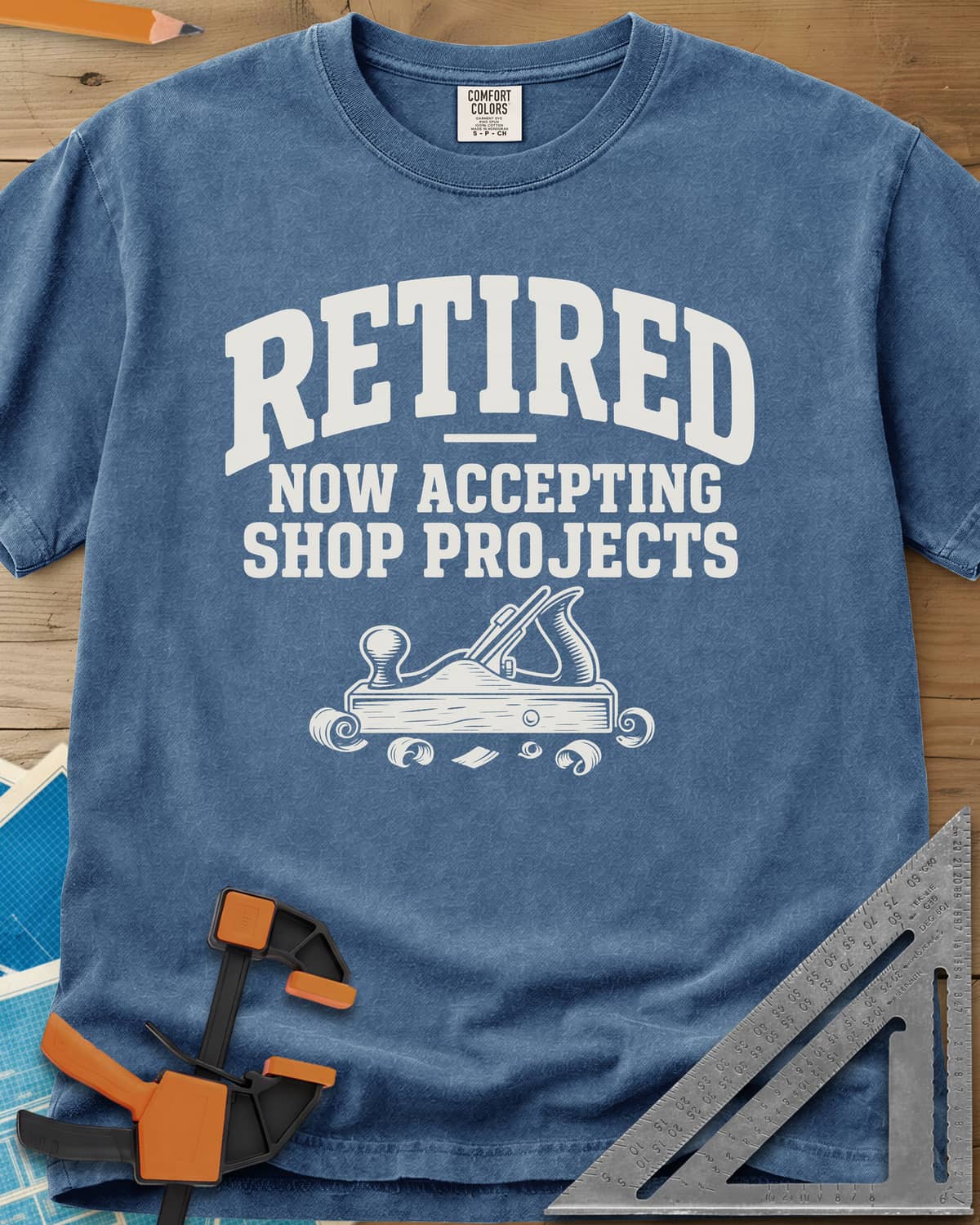 Retired Projects heavyweight tee in Blue Jean, a hand plane with curled shavings under varsity RETIRED lettering