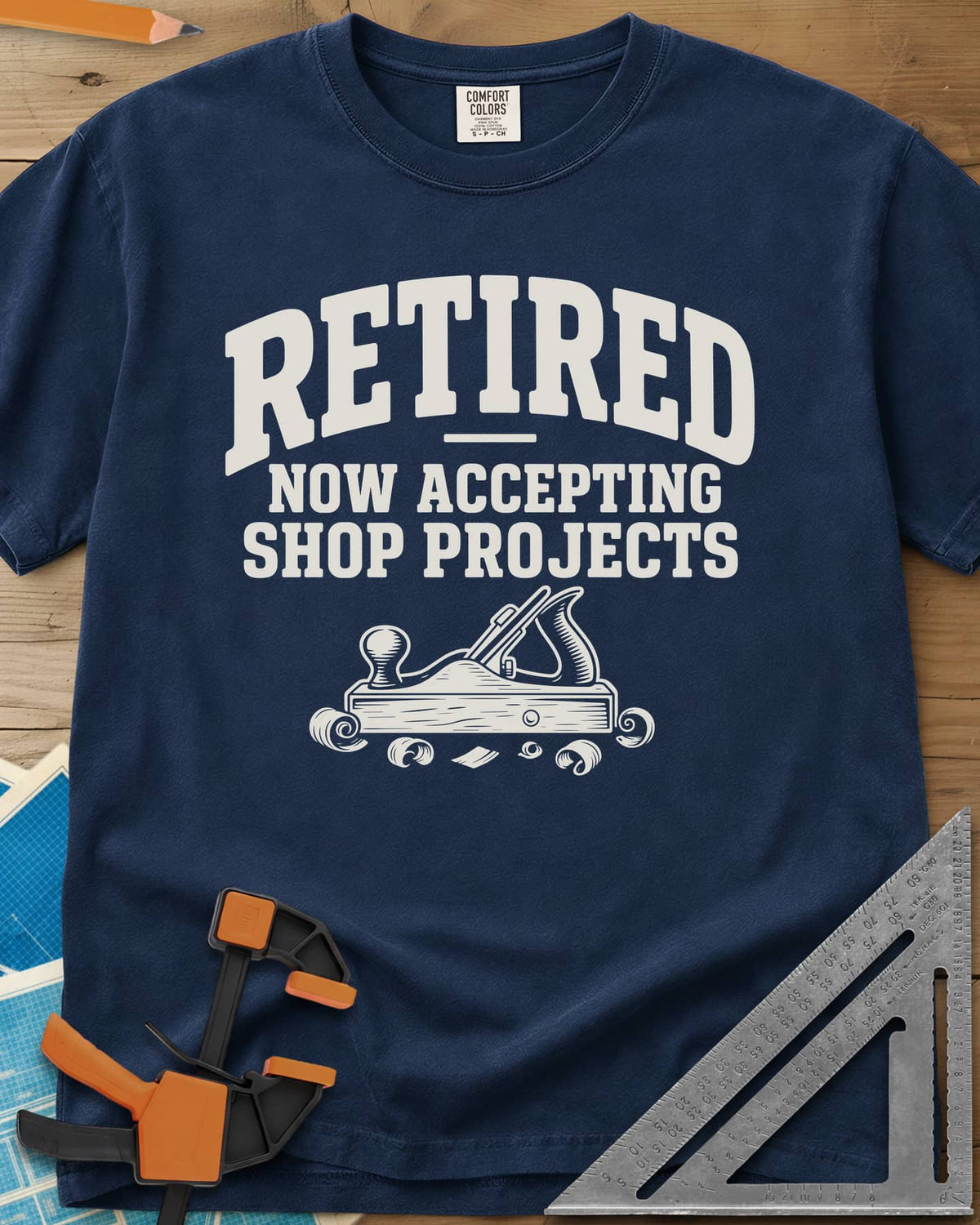 Retired Projects heavyweight tee in Navy, a hand plane with curled shavings under varsity RETIRED lettering