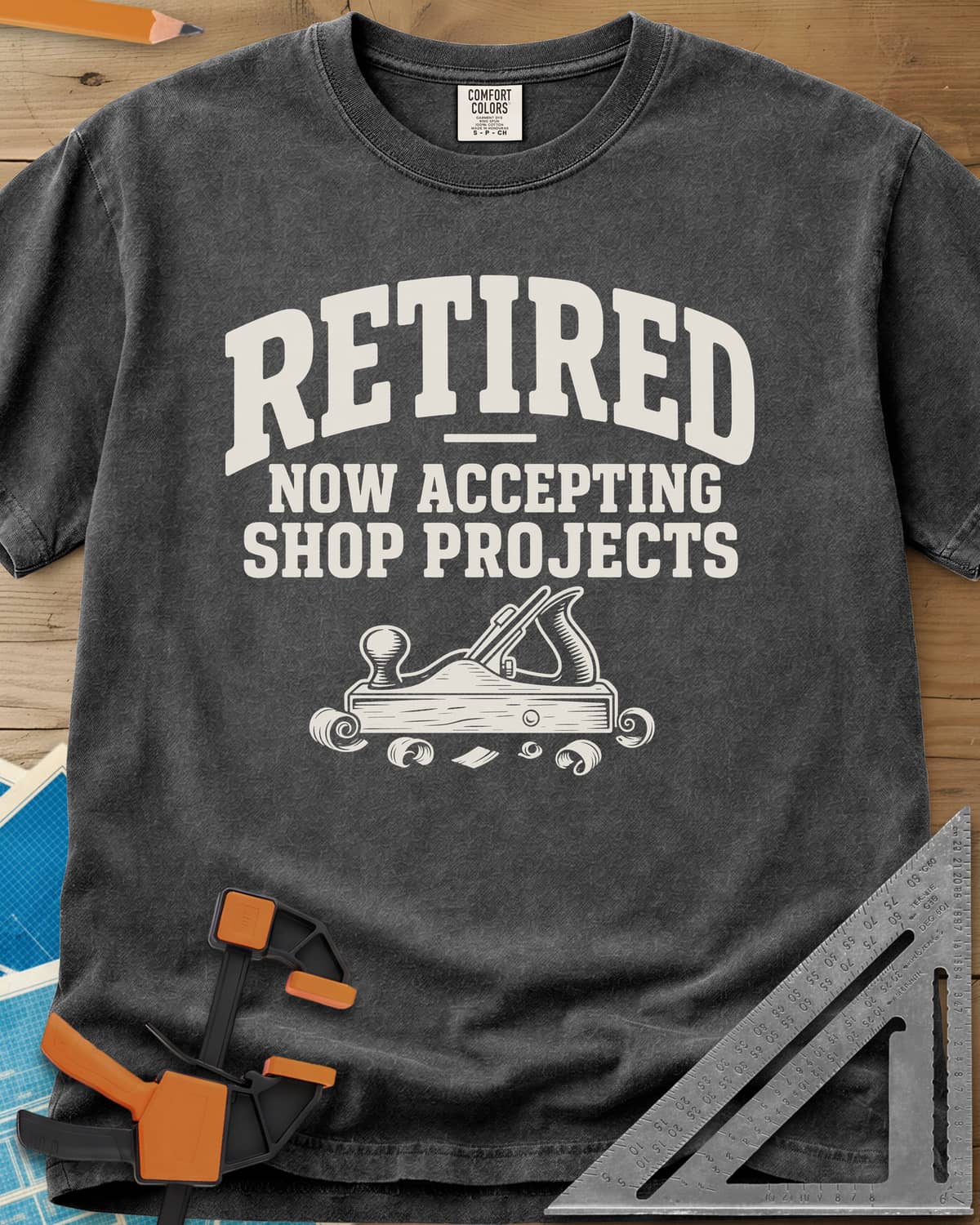 Retired Projects heavyweight tee in Pepper, a hand plane with curled shavings under varsity RETIRED lettering