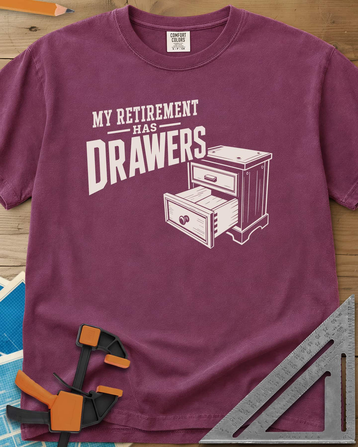 Retirement Drawers heavyweight tee in Berry, a small chest of drawers with one drawer pulled open