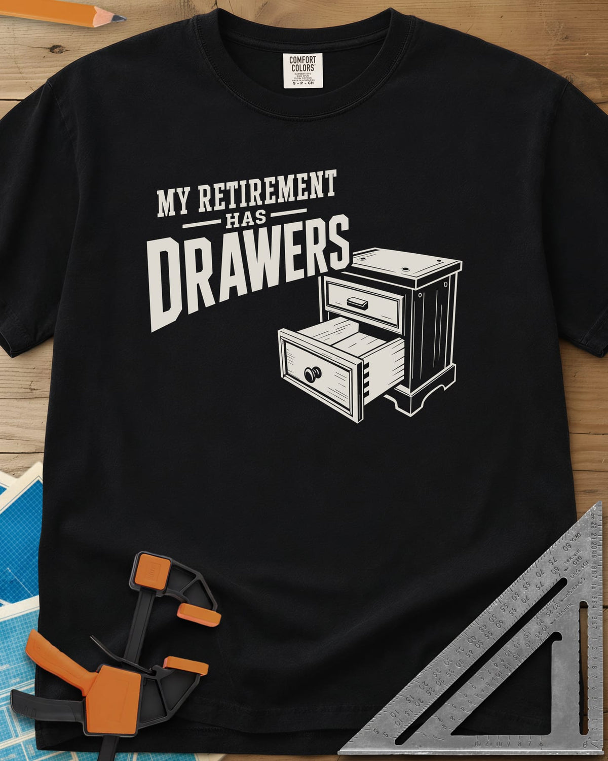 Retirement Drawers heavyweight tee in Black, a small chest of drawers with one drawer pulled open