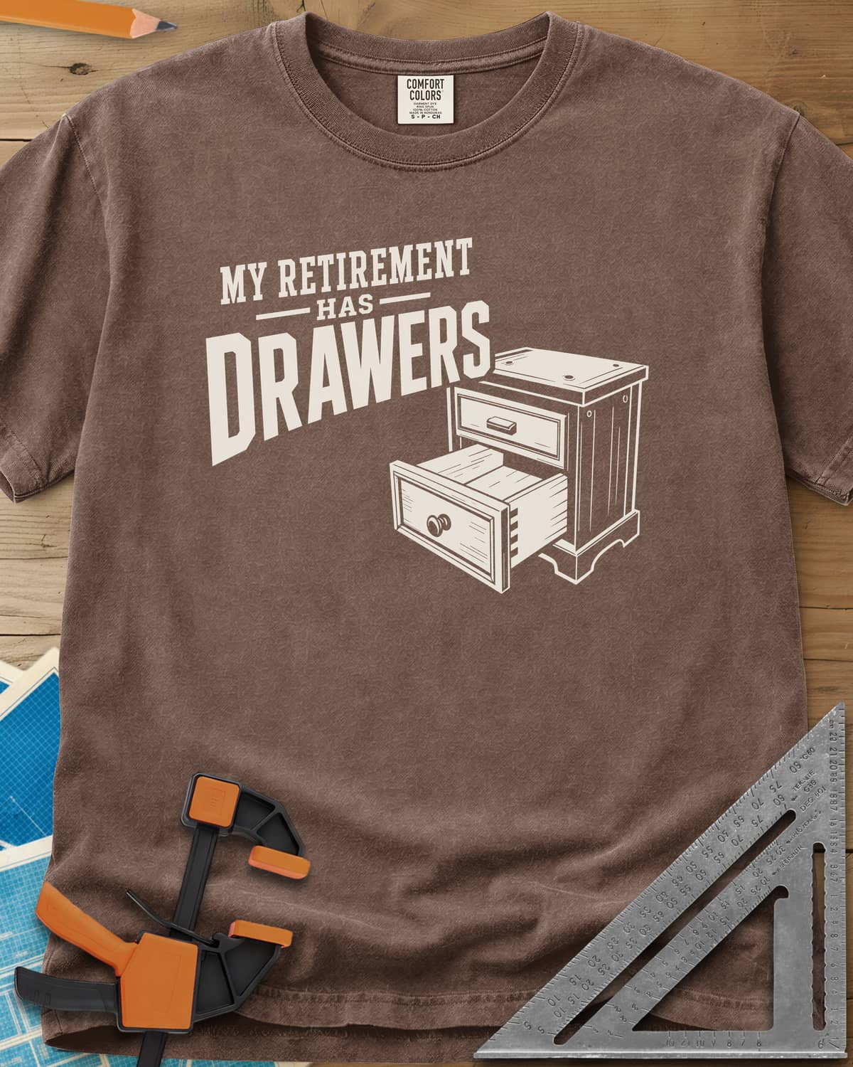 Retirement Drawers heavyweight tee in Espresso, a small chest of drawers with one drawer pulled open