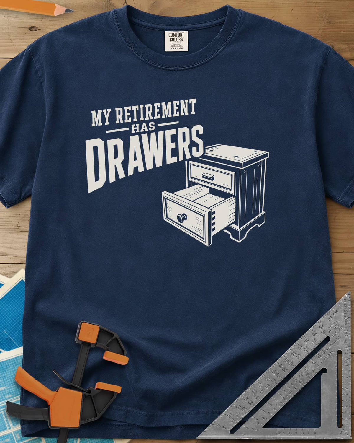 Retirement Drawers heavyweight tee in Navy, a small chest of drawers with one drawer pulled open