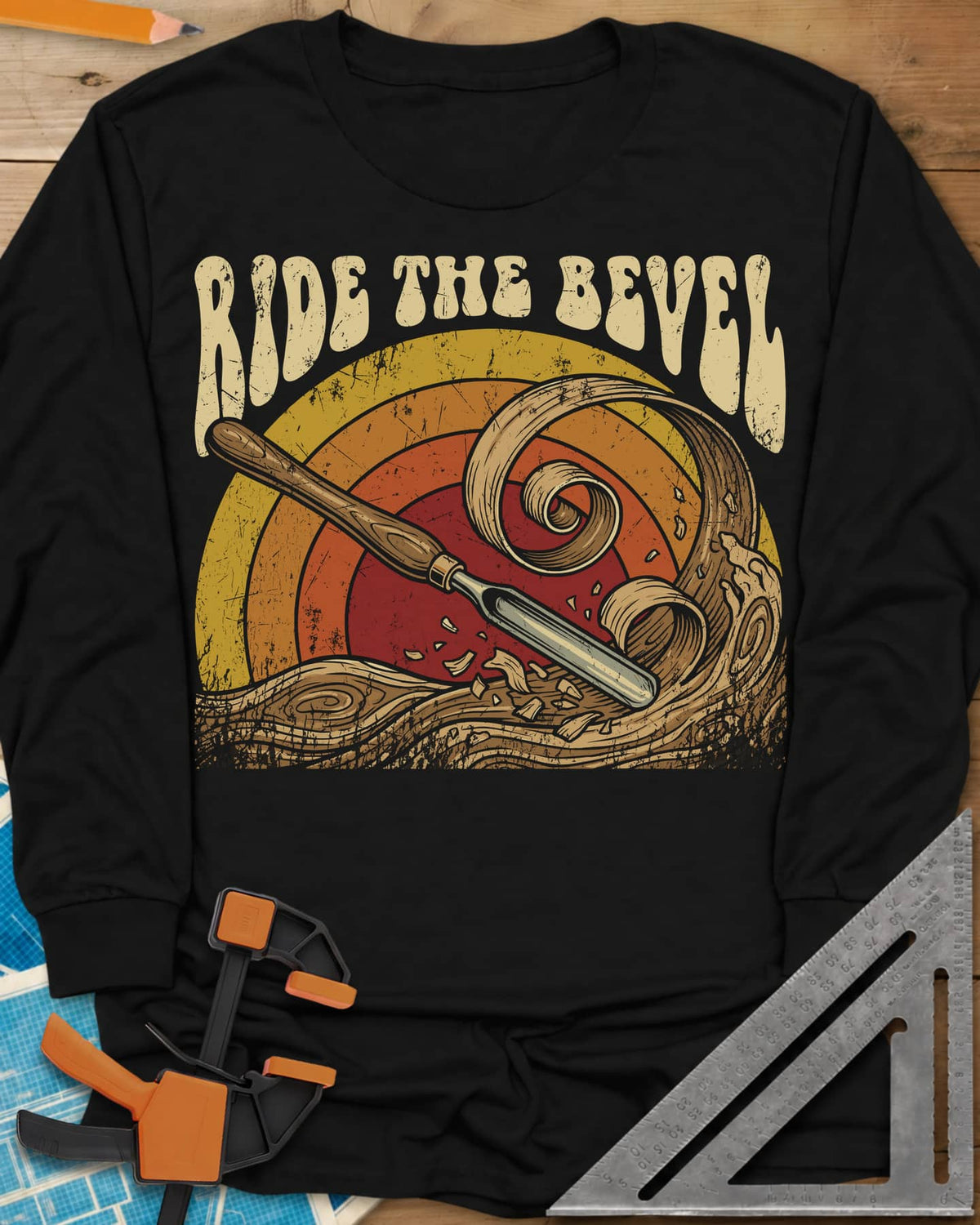 Ride The Bevel long sleeve shirt in Black, a carving gouge riding a wave of wood curls under a retro sunset
