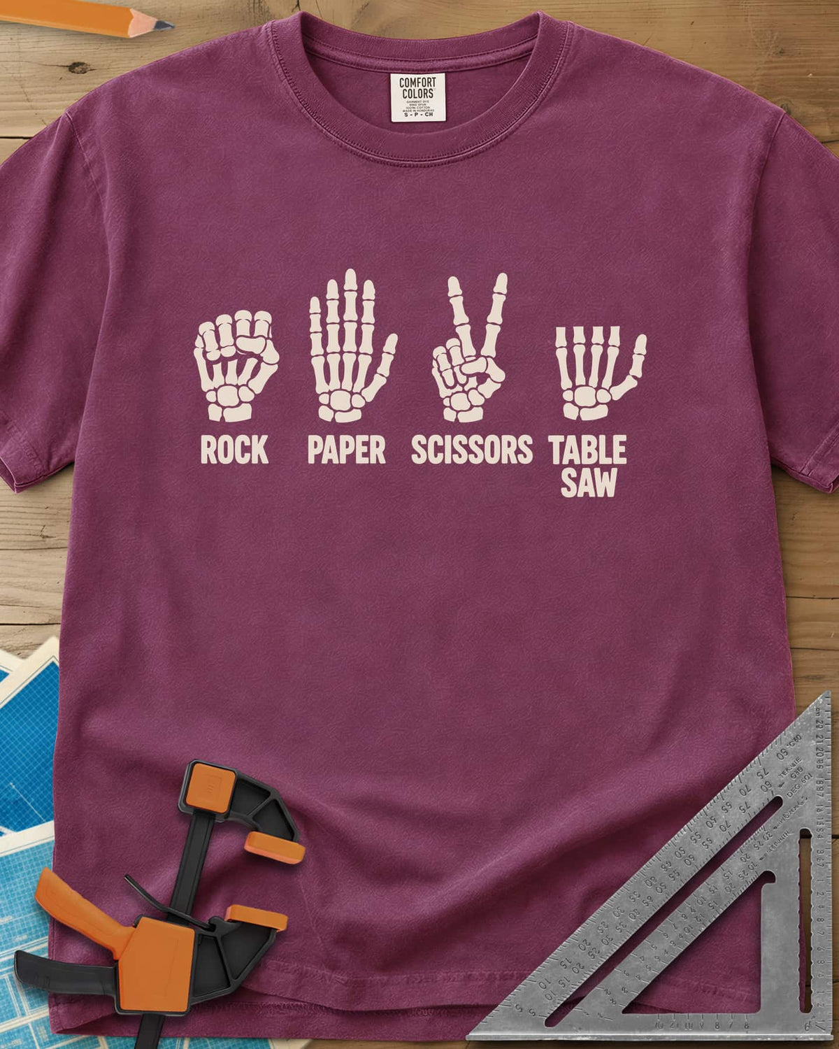Rock Paper Saw heavyweight tee in Berry, four skeleton hands, the last with its fingers cut short