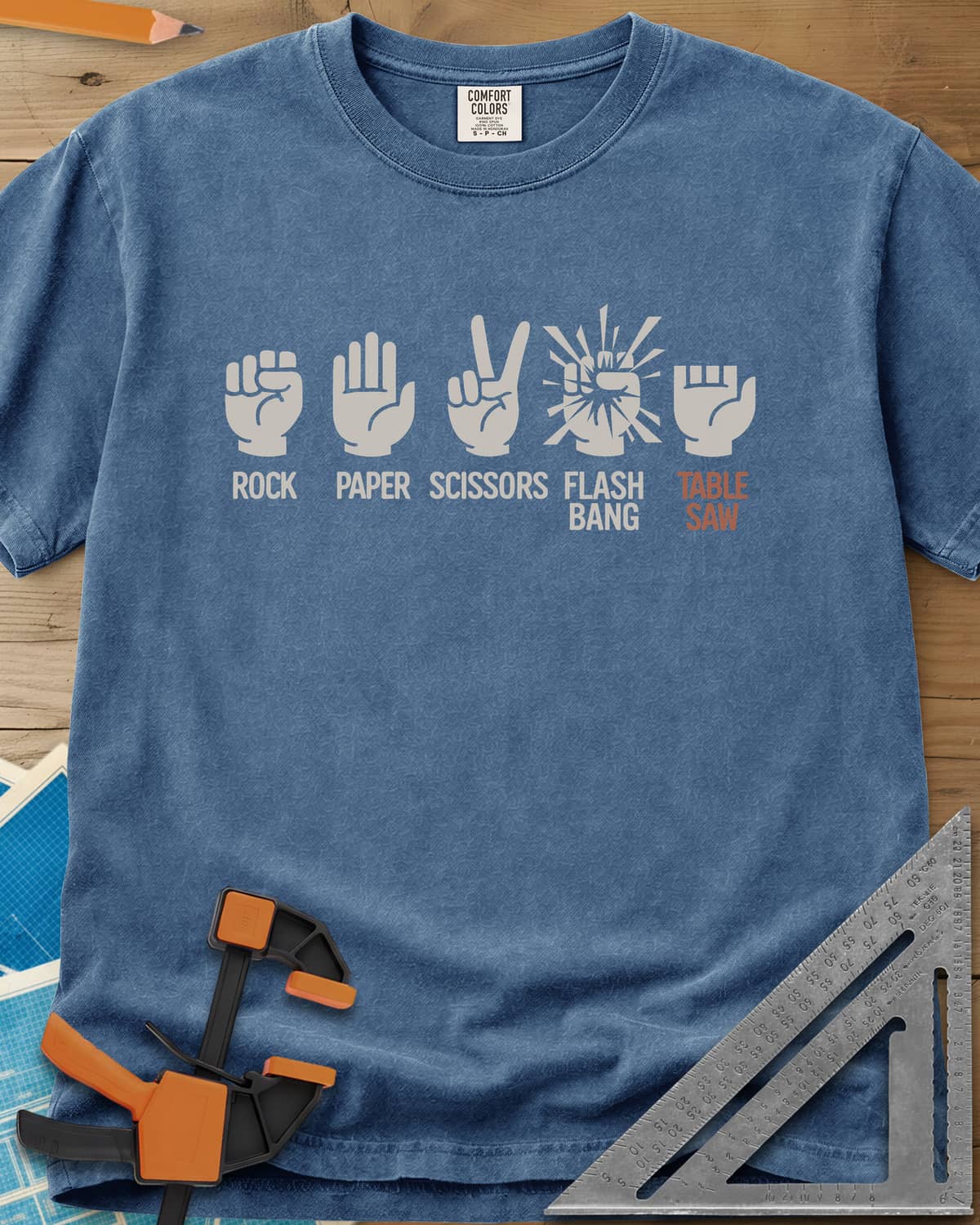 Rock, Paper, Scissors, Flashbang, Table Saw heavyweight tee in Blue Jean, five hand signs, the last a hand with its fingers