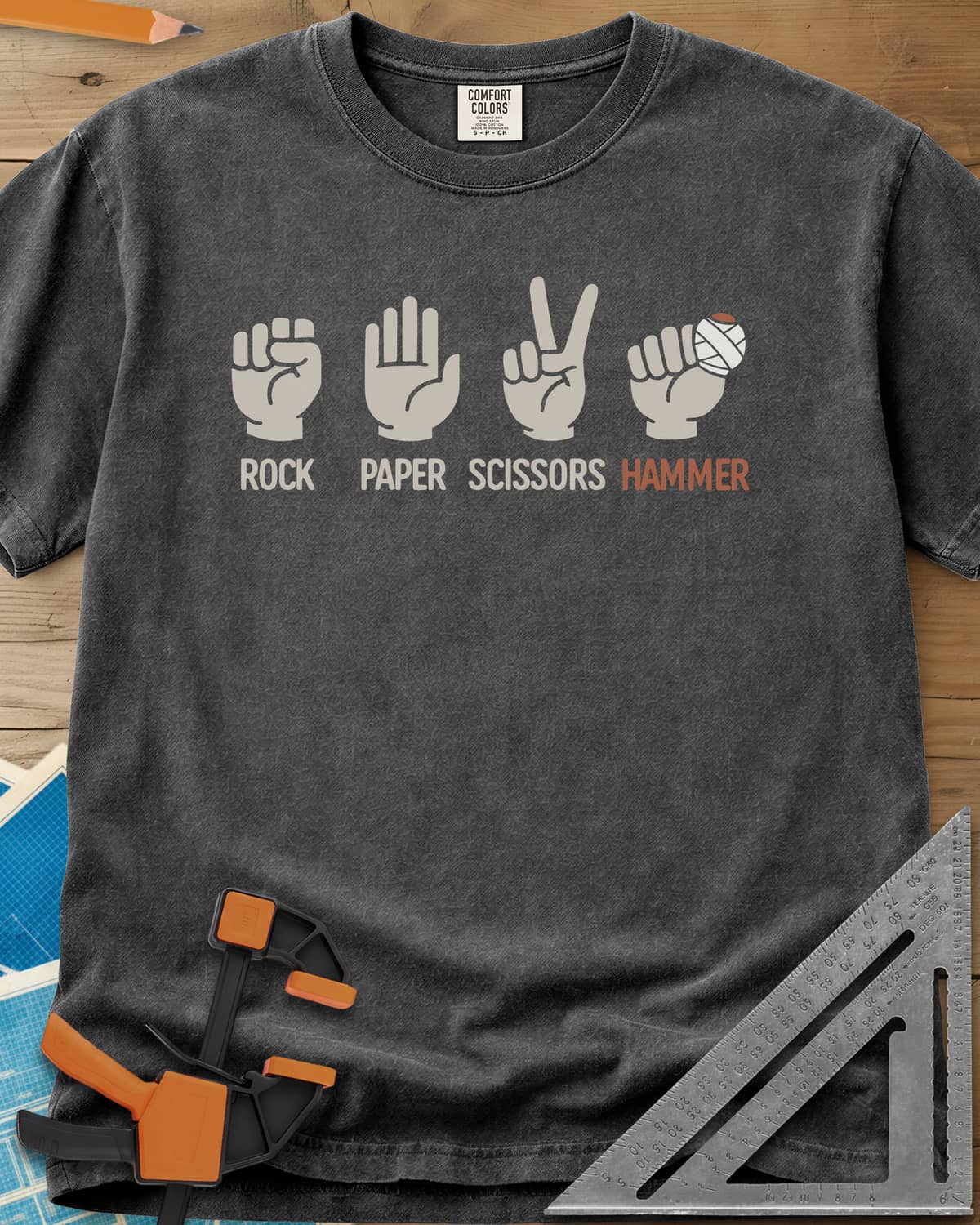 Rock, Paper, Scissors, Hammer heavyweight tee in Pepper, four hand signs, the last a fist with a bandaged thumb