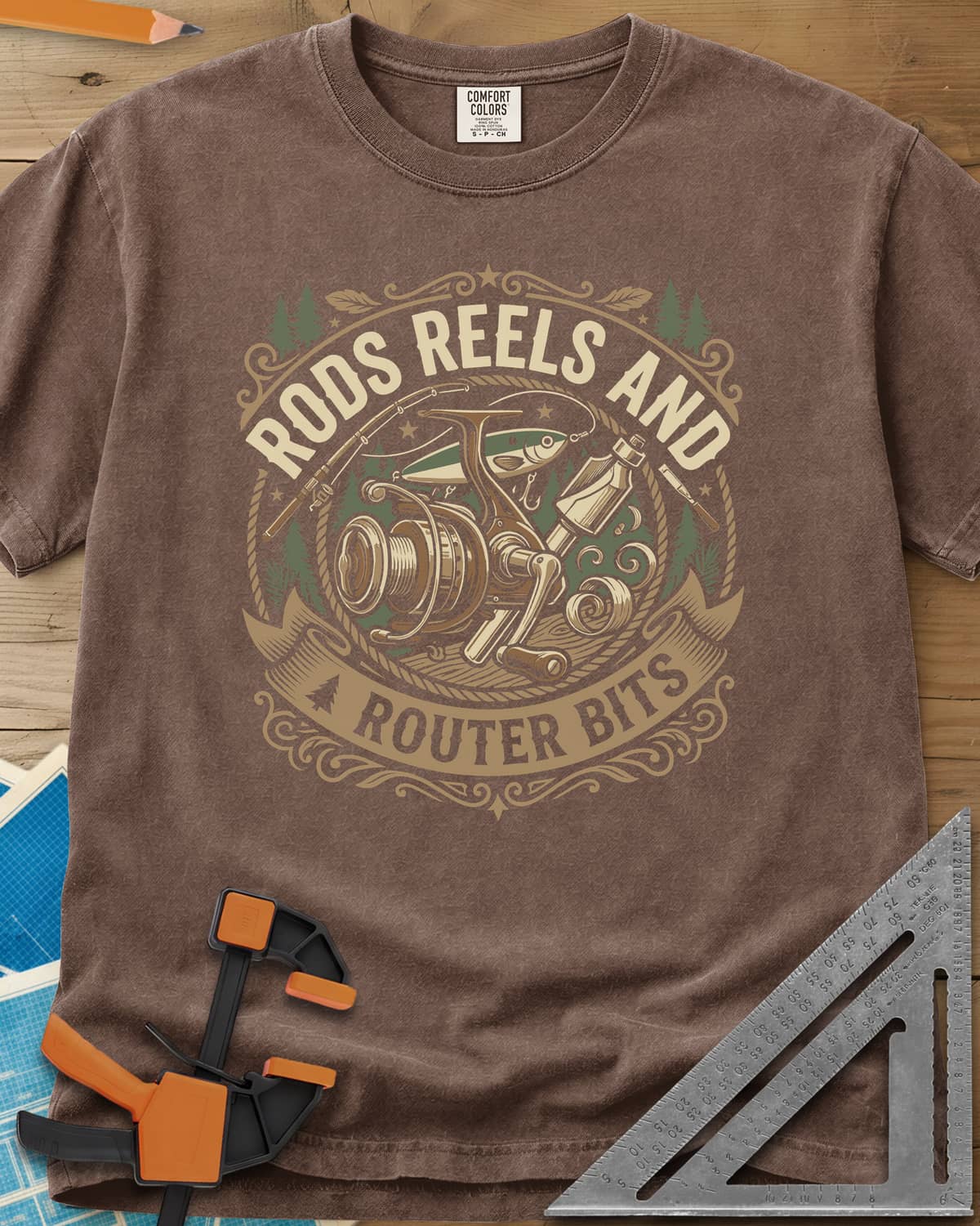 Rods Reels And Router Bits heavyweight tee in Espresso, a round badge with a fishing reel, rods, a lure and a router bit