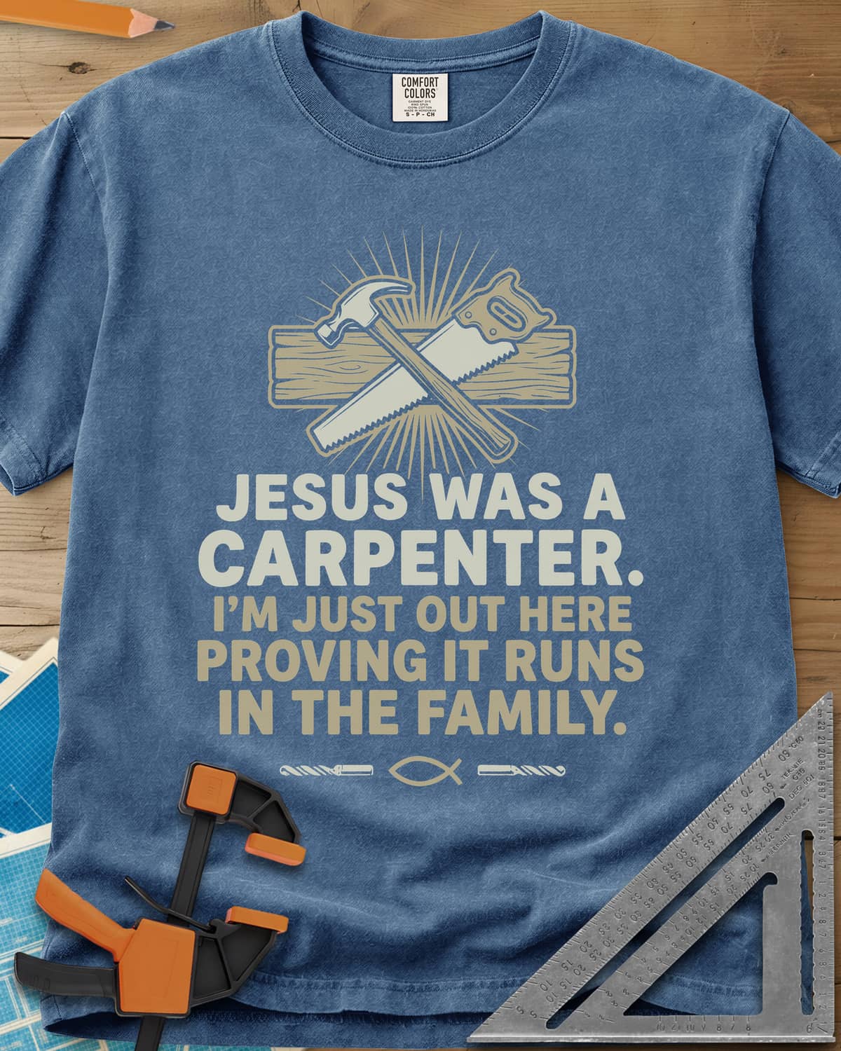 Runs In The Family Jesus Carpenter heavyweight tee in Blue Jean, crossed hammer and handsaw over a plank, with a small fish