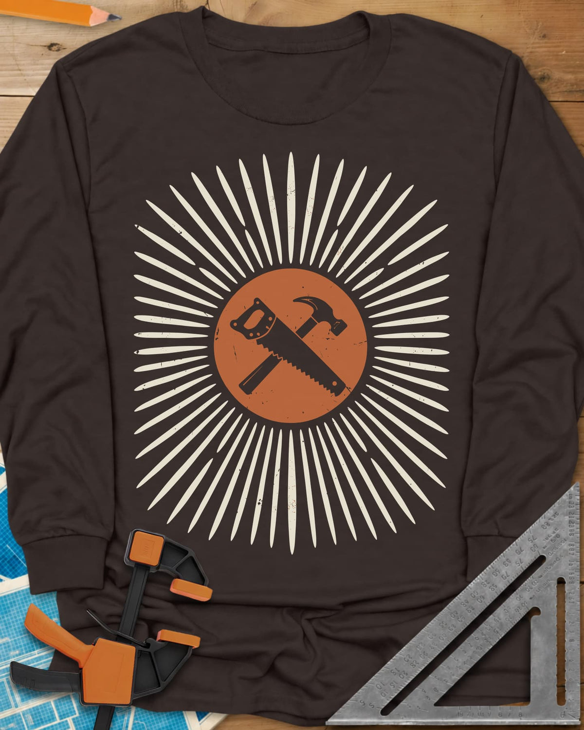 Saw & Hammer long sleeve shirt in Dark Chocolate, crossed handsaw and hammer on a rust circle in a sunburst of rays
