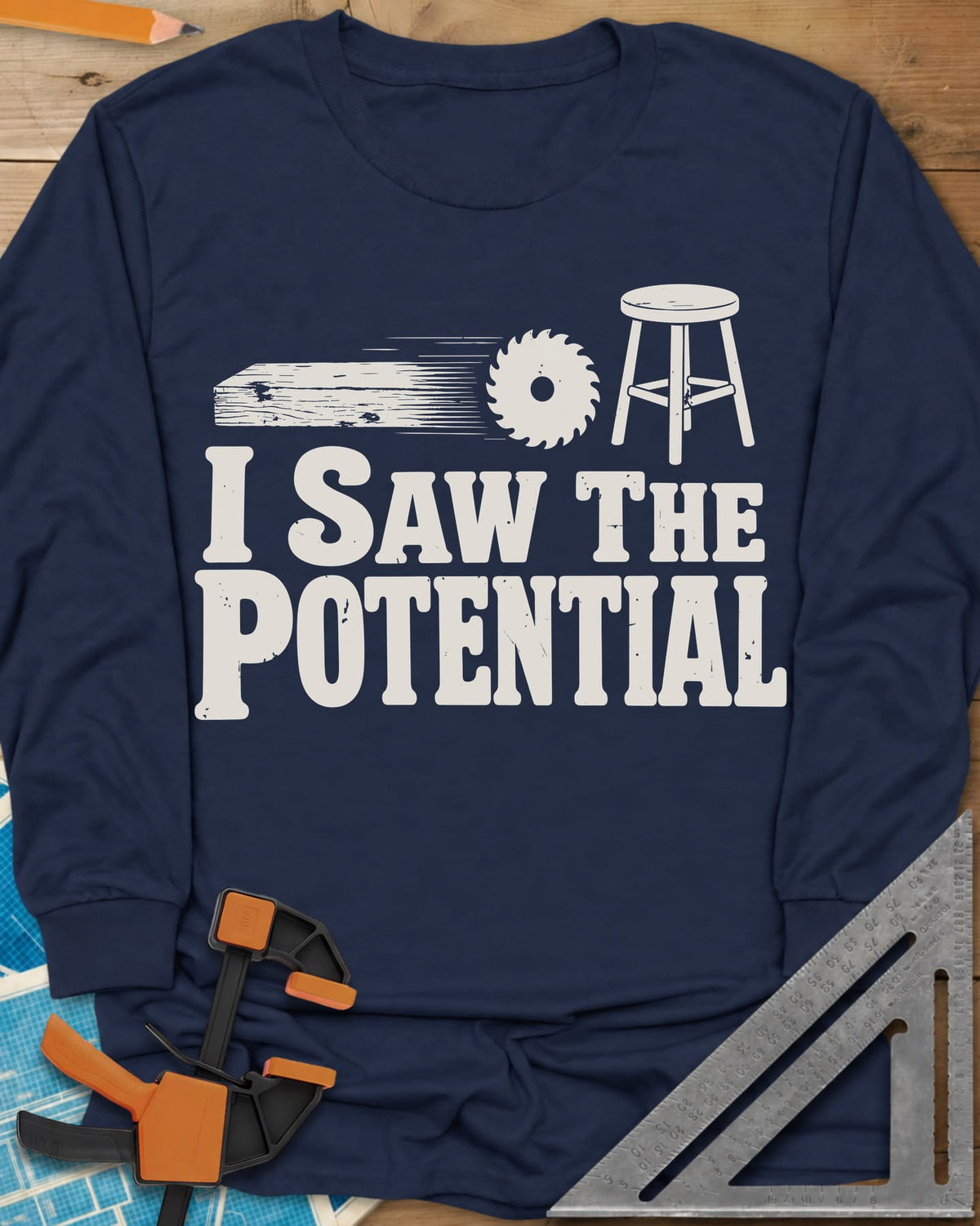 Saw The Potential long sleeve shirt in Navy, a speeding plank, a saw blade and a finished stool
