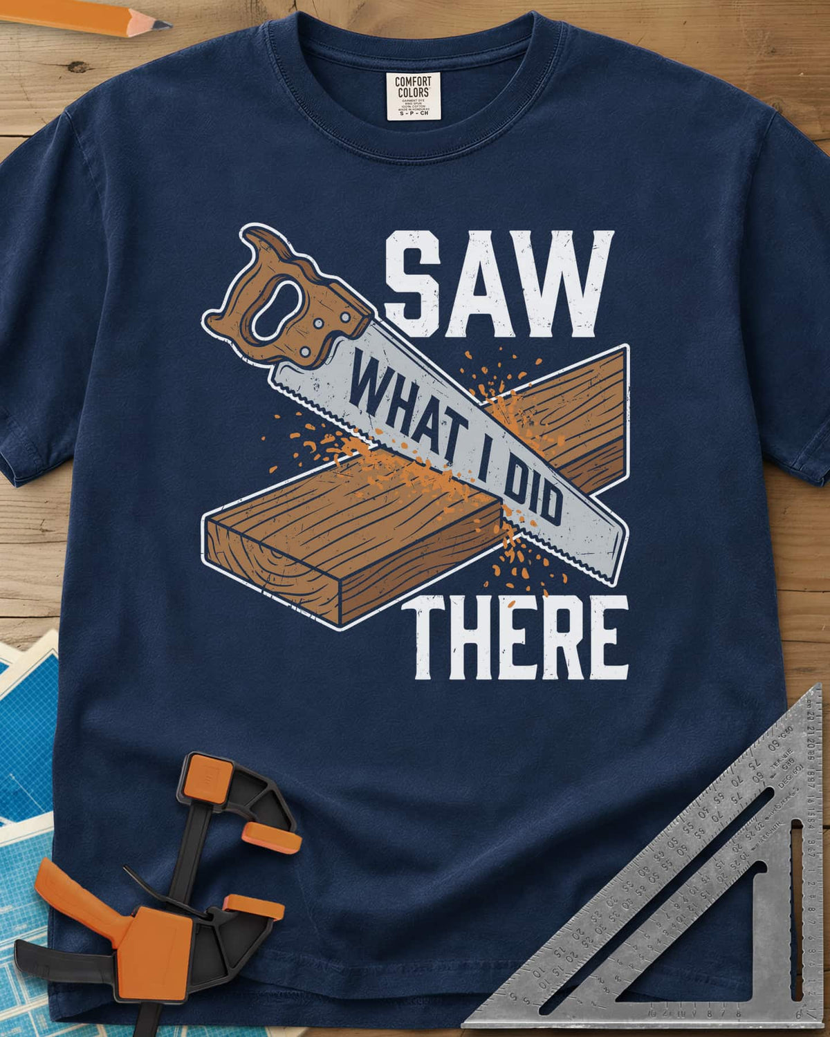 Saw What I Did heavyweight tee in Navy, a hand saw cutting a plank with WHAT I DID lettered on its blade