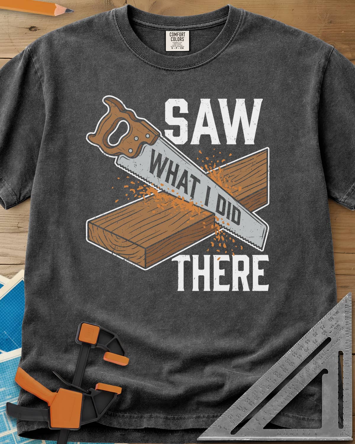 Saw What I Did heavyweight tee in Pepper, a hand saw cutting a plank with WHAT I DID lettered on its blade